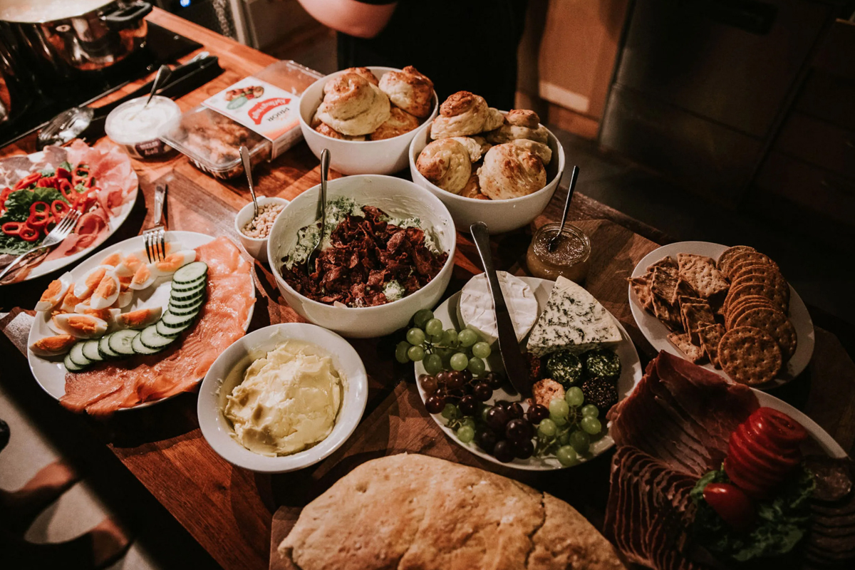 A spread of breakfast dishes at Alten Lodge, including cured meats, cheese, and fresh bread.
