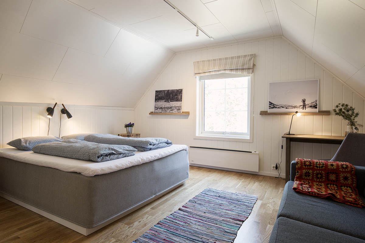 Bright attic bedroom with a double bed at the Trasti & Trine main house.