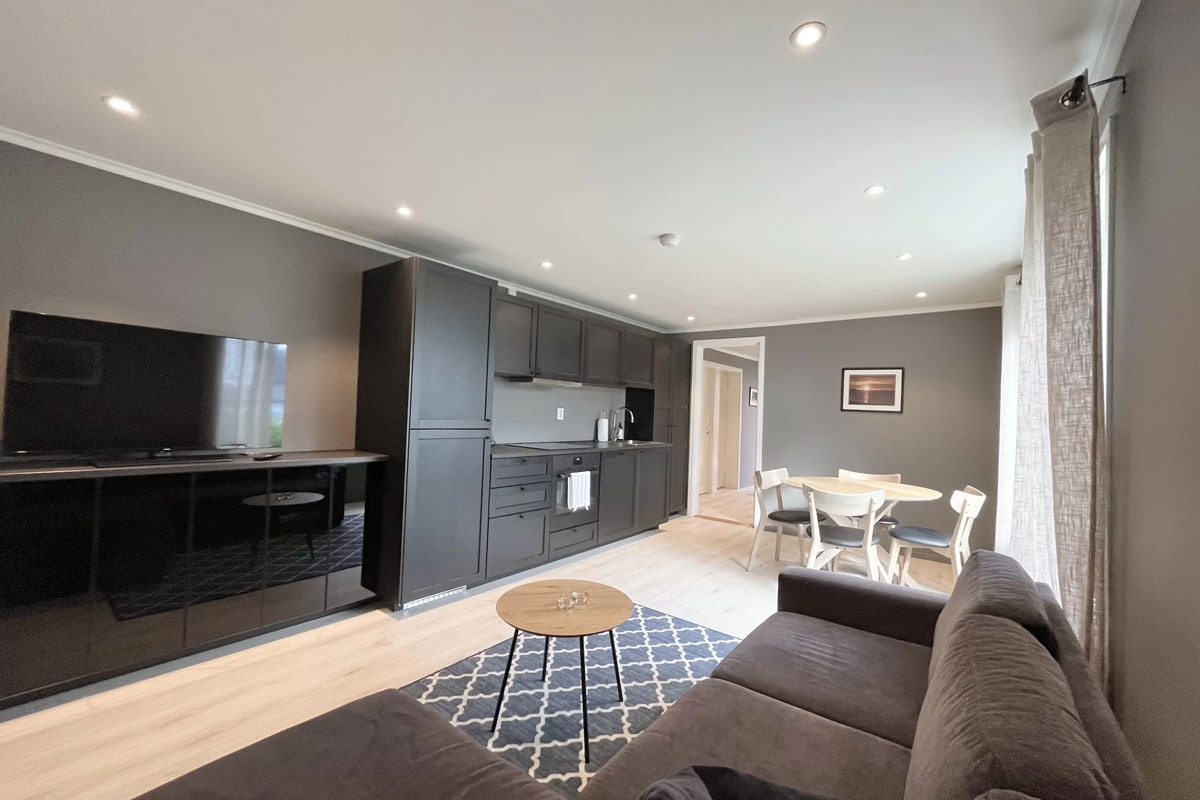 Modern open-plan living room and kitchen in a renovated house at Varanger Brygge Bugøynes