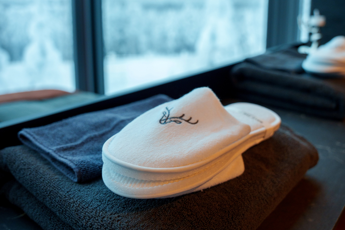 Slippers and towels inside an Aurora Room at Lumo Resort in Ruka.