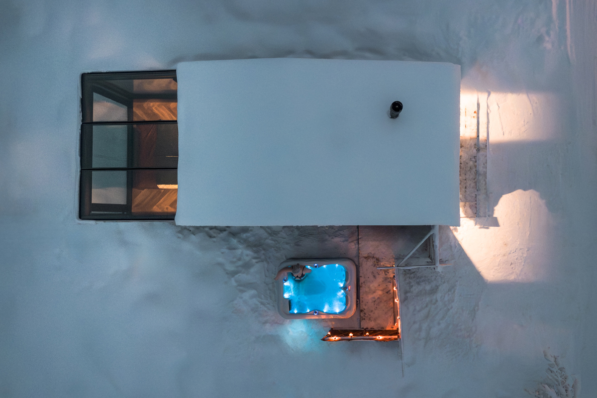 Aerial view of an Aurora Spa Room at Lumo Resort in Ruka, with lit outdoor hot tub.