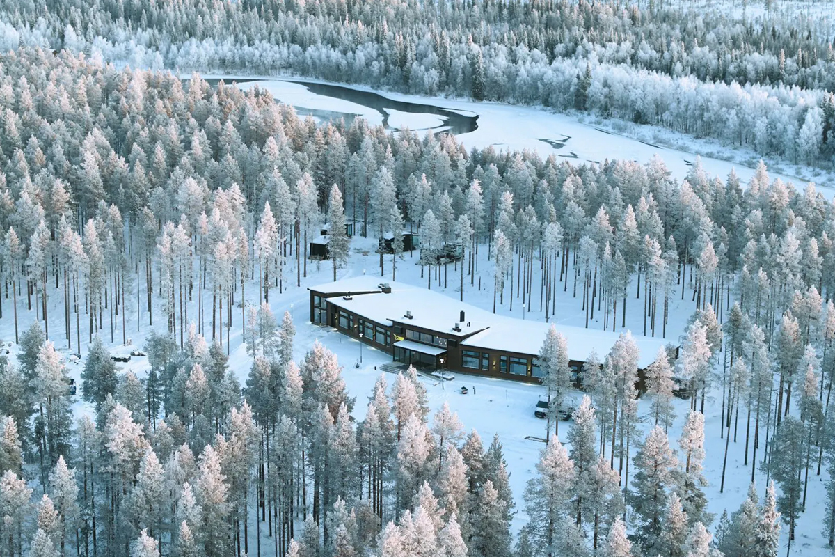Aerial view of the main property at Balder Luxury Lodge in Levi, beside a winding river.