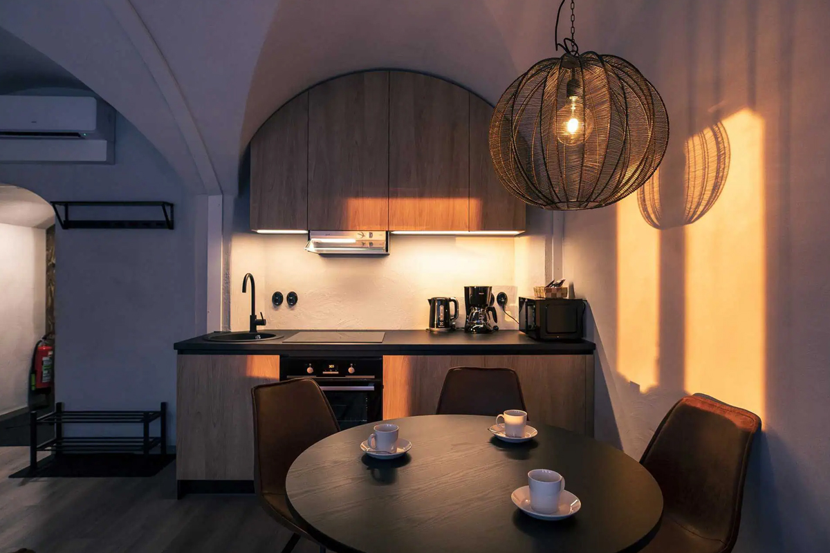 Dining area in the Lakeview Suite at Apukka Resort with a round table and pendant light.