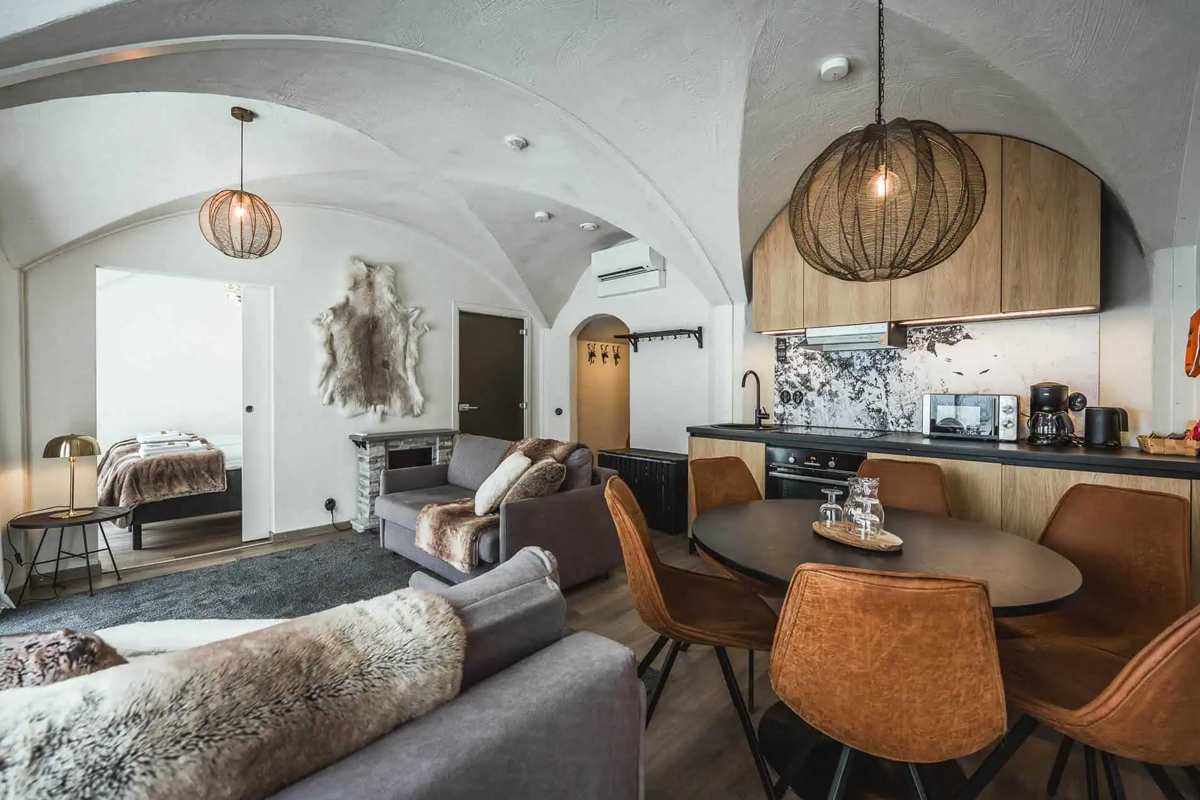 Open plan lounge and kitchen in the Lakeview Suite at Apukka Resort with fur accents.