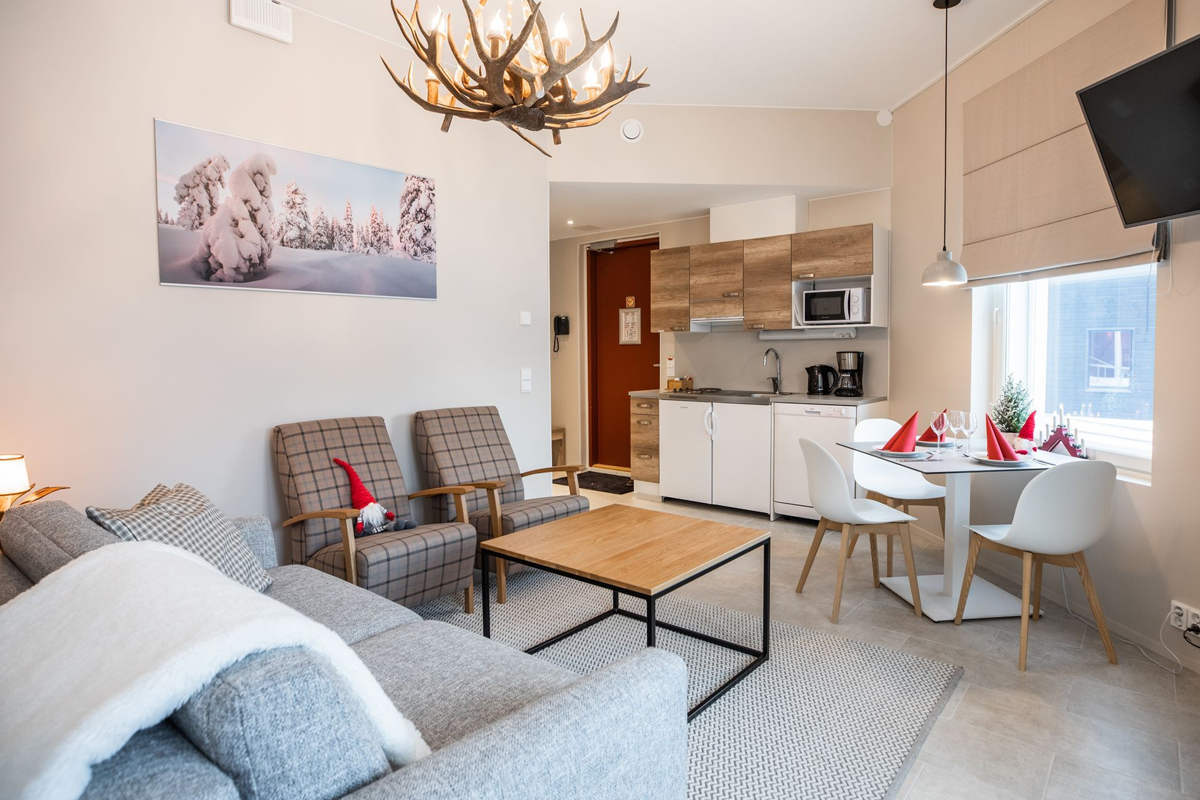 Classic suite living room with antler chandelier and kitchenette, Santa Claus Holiday Village, Rovaniemi