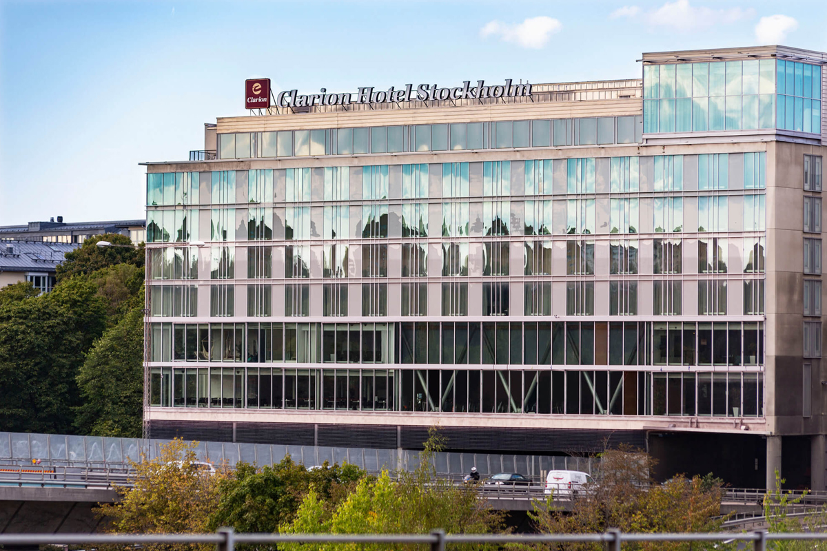 Exterior of Clarion Hotel Stockholm in Södermalm, a modern glass-fronted building with views over the surrounding city.