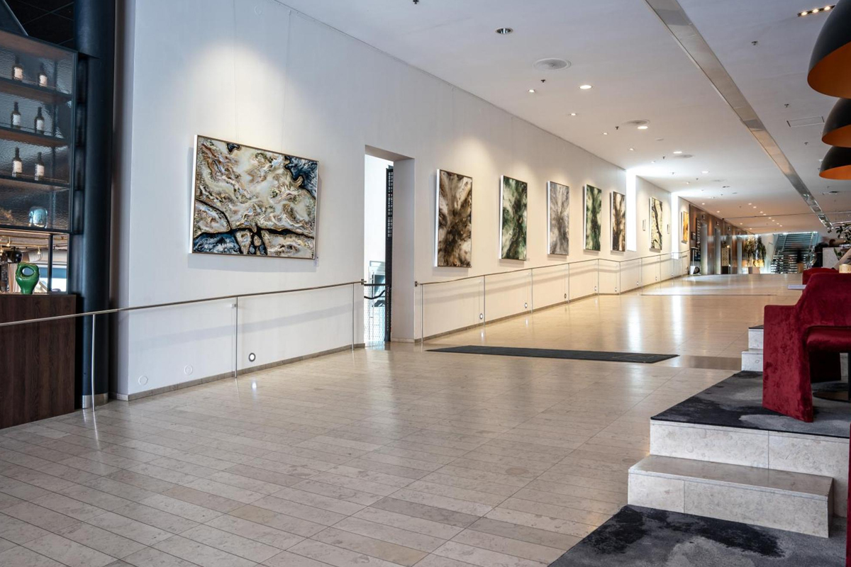 Art display in the lobby corridor at Clarion Hotel Stockholm in Södermalm, featuring large-format Scandinavian contemporary paintings.