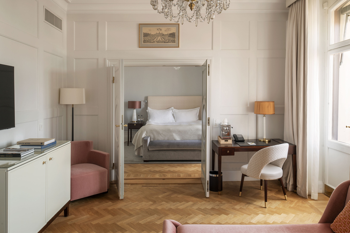 Living room of a Superior Suite at Grand Hôtel Stockholm, with double doors opening into the bedroom, a writing desk, and elegant furnishings.