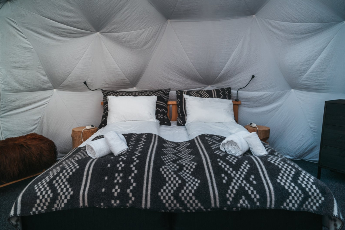Cosy double bed inside an Aurora Igloo at Aera in Tromso.