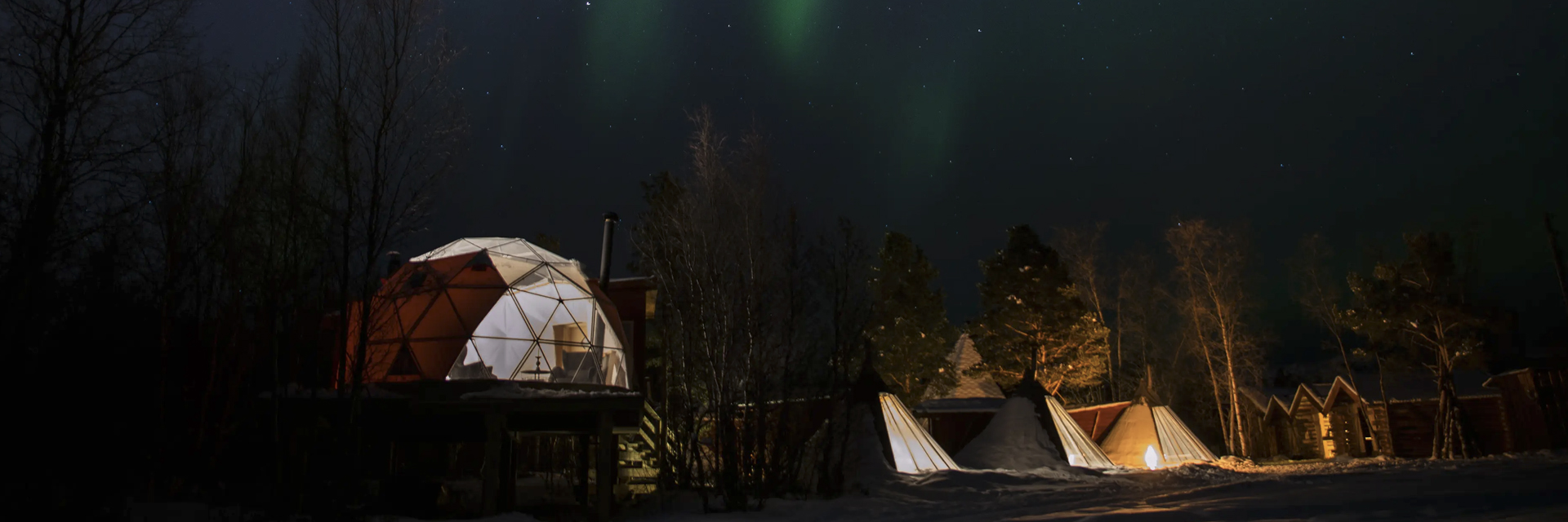 Aurora Igloo and lavvu tents at Aera in Tromso, under the northern lights.