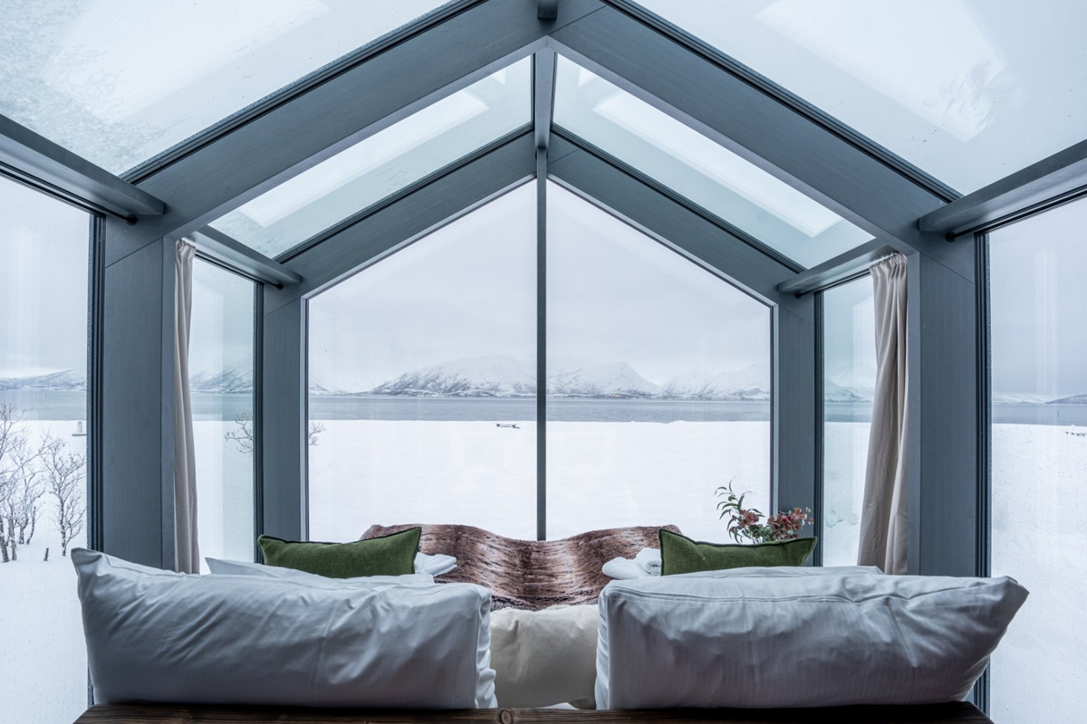 View from the bed inside a Panorama Glass Lodge at Aera, facing the fjord.