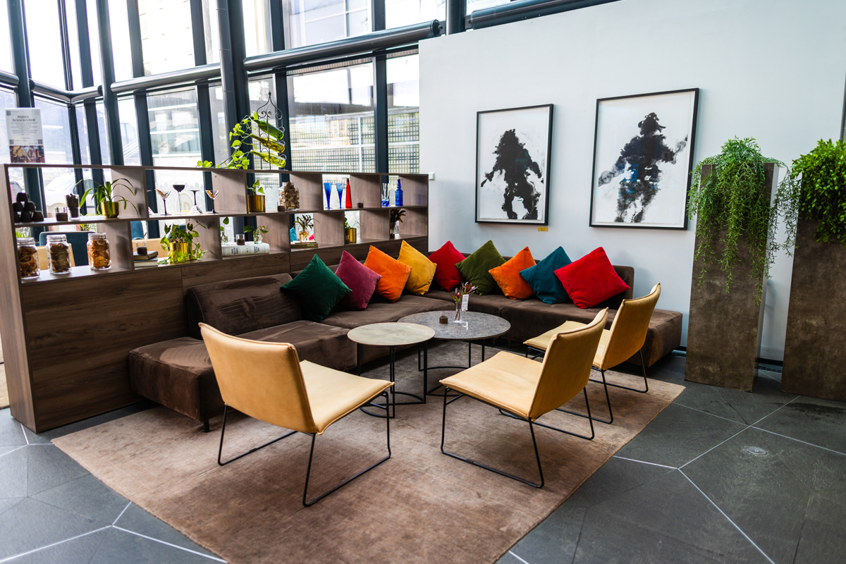 A colorful lounge seating area with patterned pillows and plants at Clarion Hotel The Edge, Tromso.