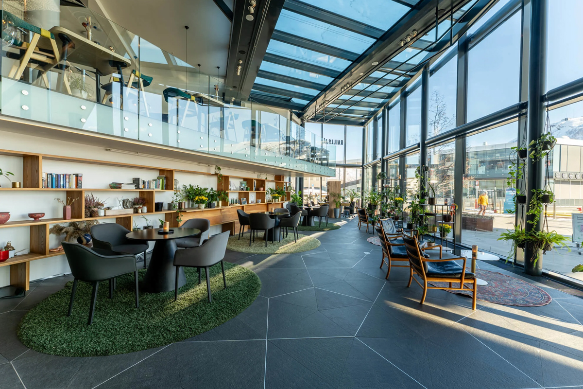 A glass-roofed lounge with greenery and mountain views at Clarion Hotel The Edge, Tromso.