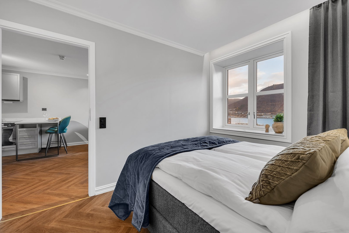 Bedroom at St. Elisabeth Hotel & Spa in Tromso, with a water view and access to an open kitchen.