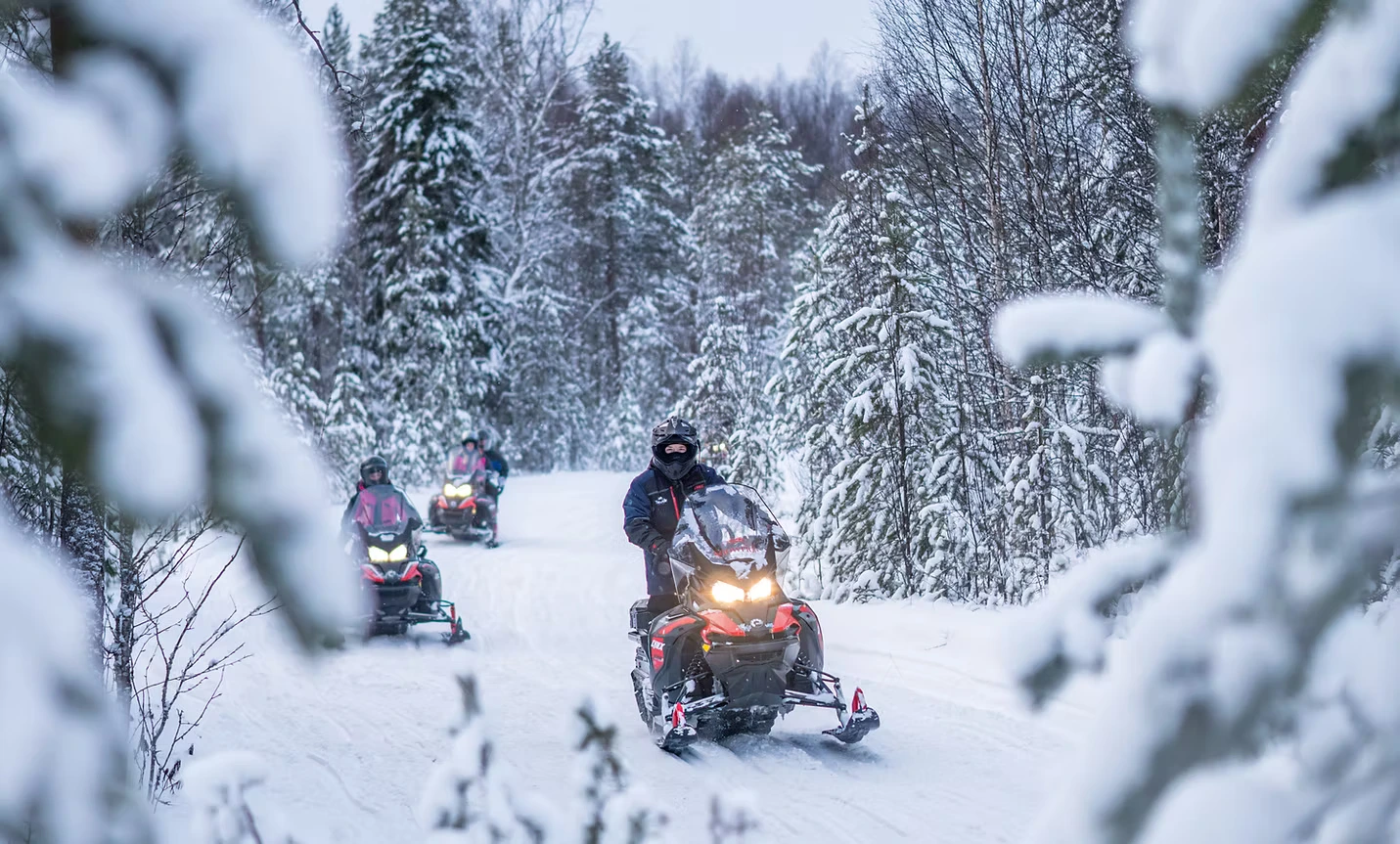 Two Snowmobile in a deep snow forest in Lapland near Rovaniemi