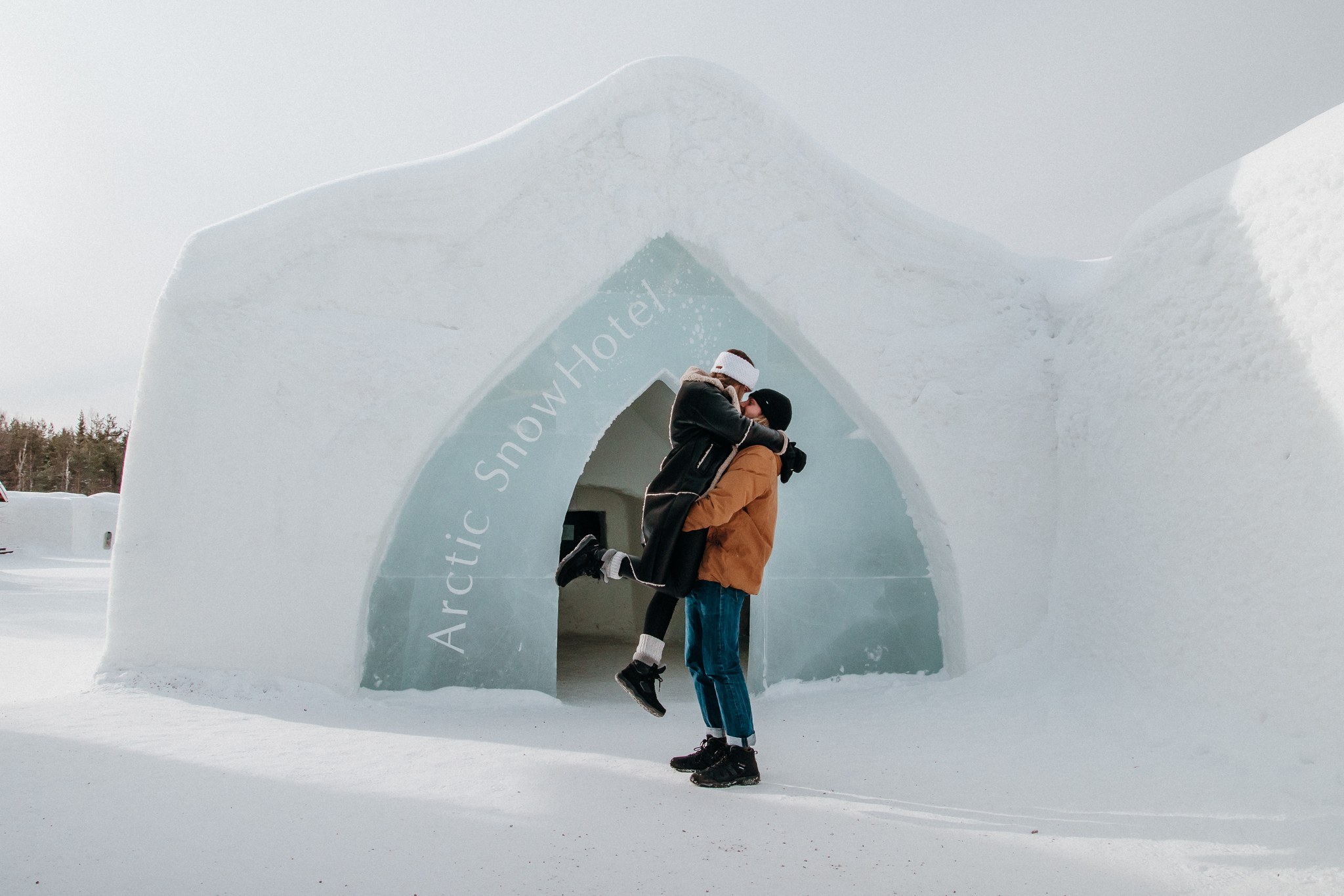 Couple in front of the arctic snowhotel entrance in Lapland