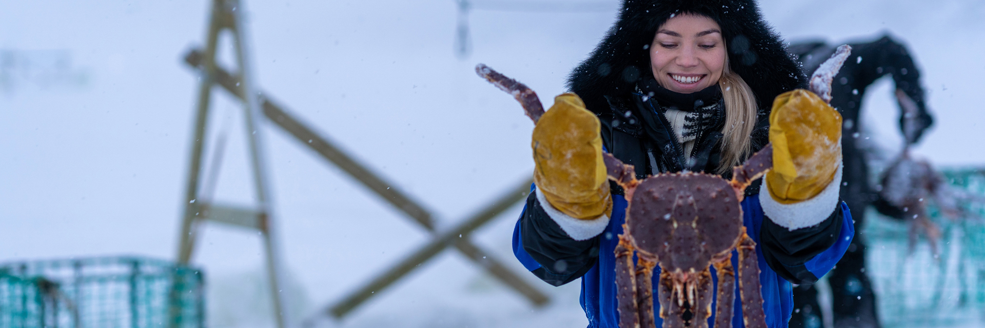 Guest holding a freshly caught king crab during a King Crab Safari with Snow Resort Kirkenes.