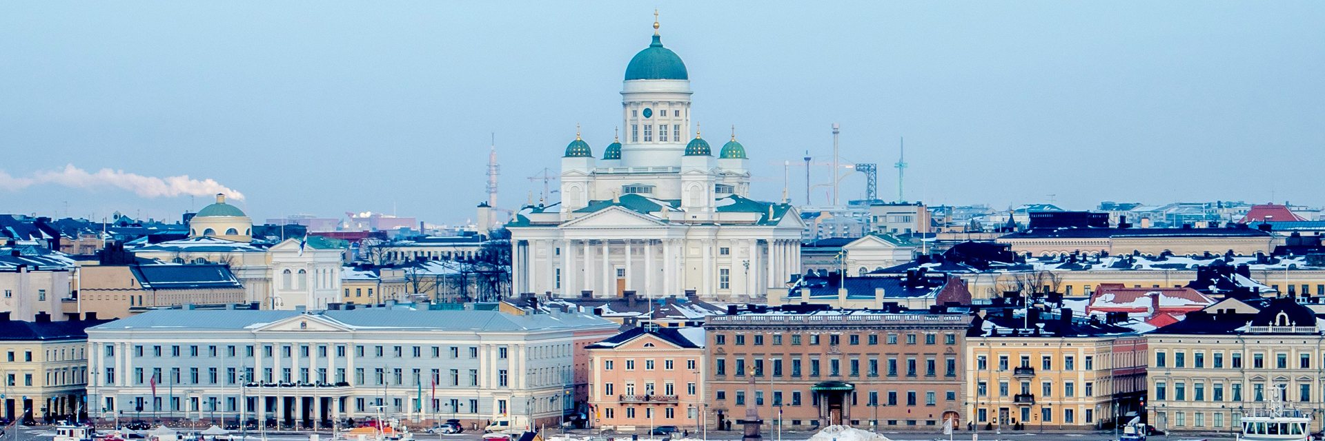 Helsinki Cathedral and waterfront skyline in winter, seen from the harbour.