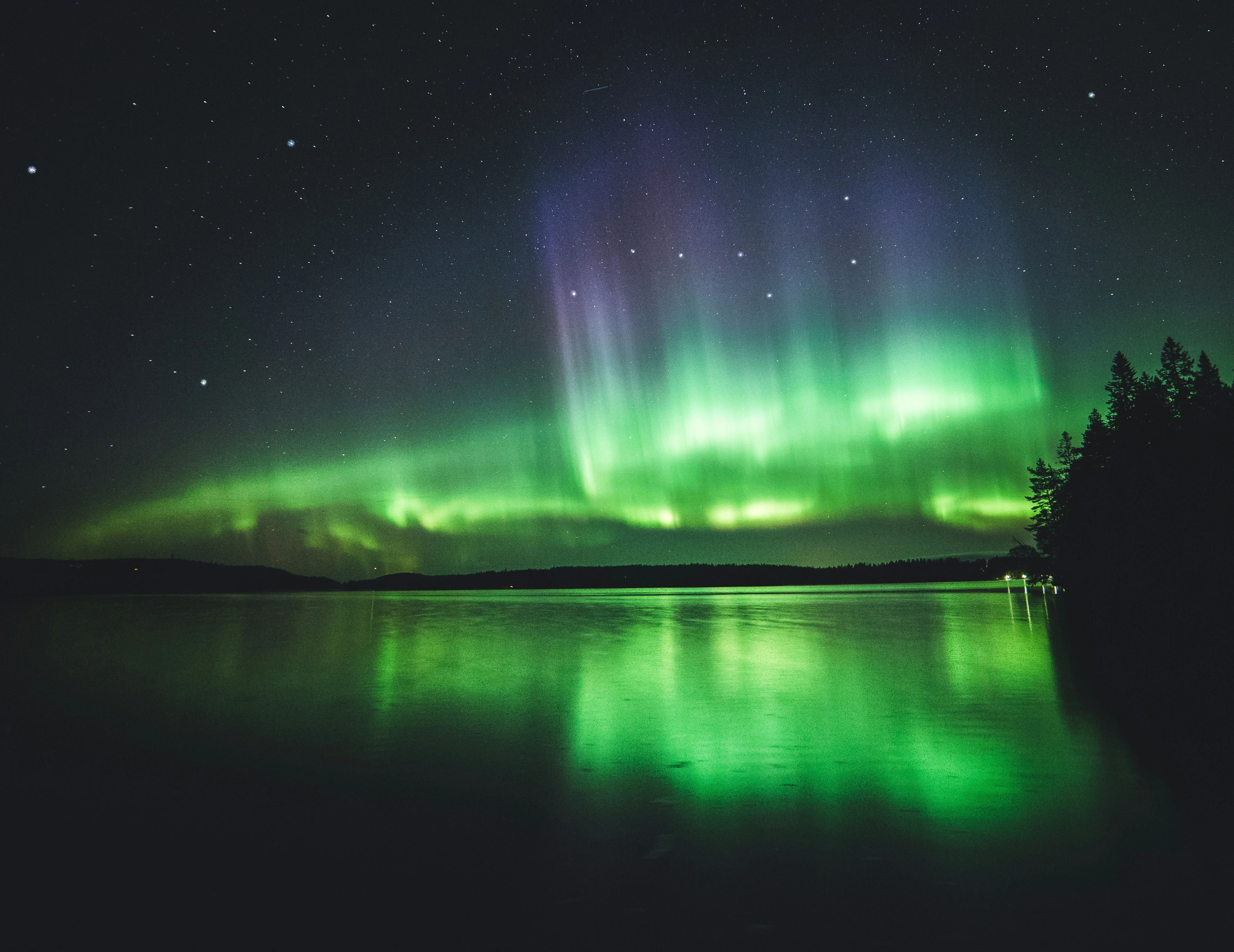 Northern Lights in Finland in August above a Lake