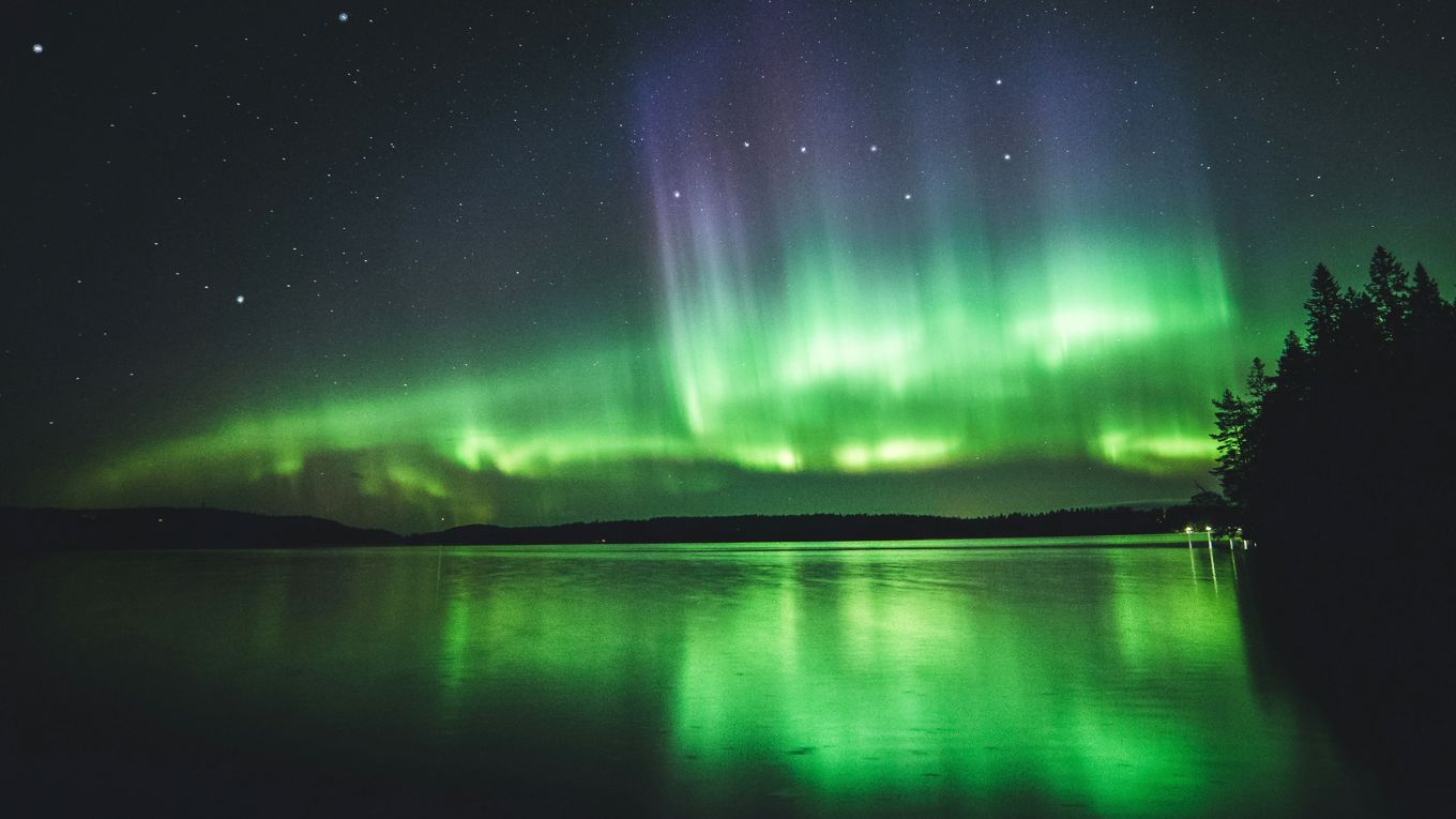 Northern Lights in Finland in August above a Lake